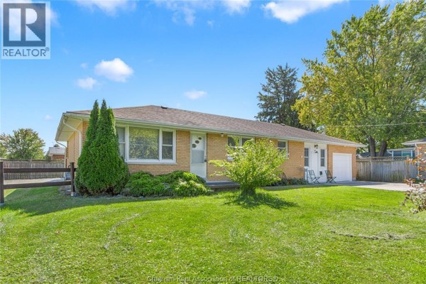 Bedroom with a twin bed, grey armchair, and a window with blinds. - 410 Mcnaughton Avenue East, Chatham