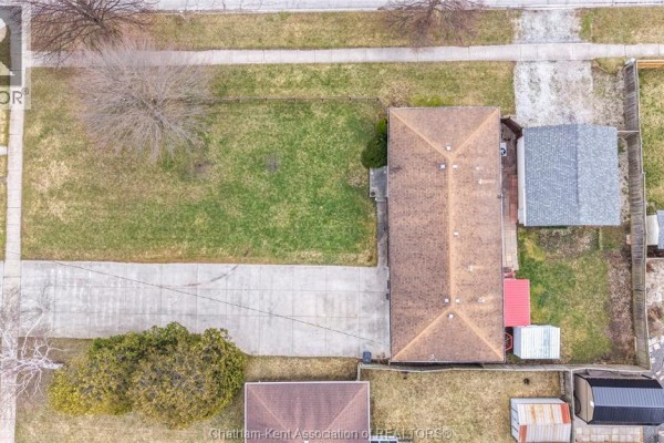 Brick house with attached garage and grass lawn - 410 Mcnaughton Avenue East Chatham
