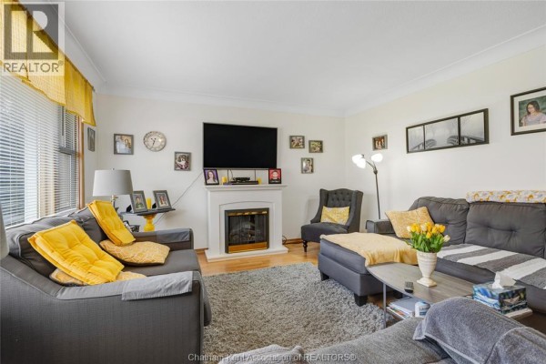 Kitchen with white appliances, cabinets, granite-top table, and chairs - 410 Mcnaughton Avenue East Chatham