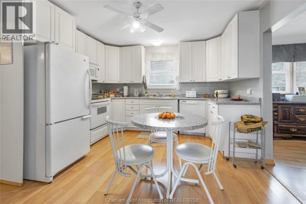 Suburban street with homes, pools, and driveways - 410 Mcnaughton Avenue East Chatham