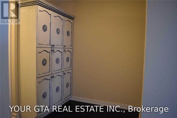 Tall white cabinet with blue decorative accents in an apartment hallway. - 4107 - 4011 Brickstone Mews, Mississauga