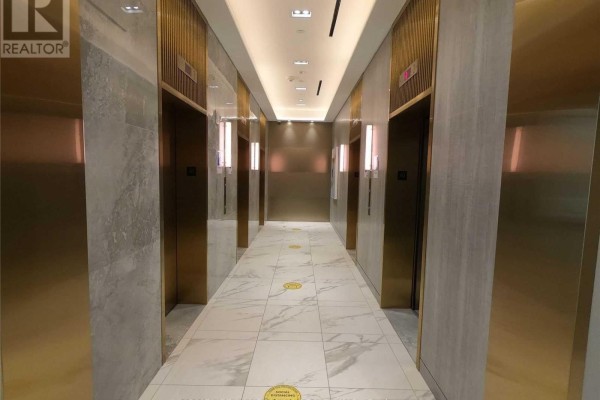 A hotel-style hallway with polished marble floors and brass elevator doors. - 4109 - 950 Portage Parkway, Vaughan