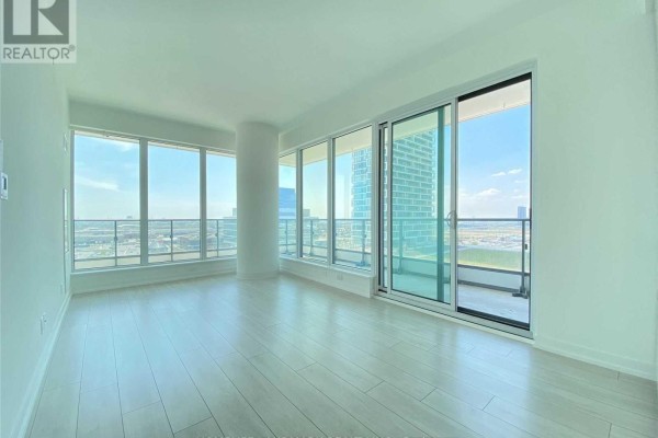 Empty living room with large windows, sliding glass doors, and a balcony. - 4109 - 950 Portage Parkway, Vaughan