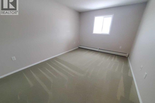 Bedroom with carpet flooring and a single window providing natural light - 411, 1615 41 Street, Edson
