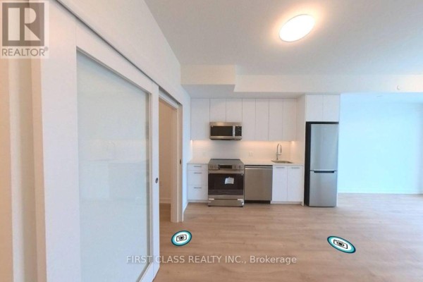 A modern kitchen with stainless steel appliances, white cabinets, and light wood floors. - 4111 - 30 Francis Street, Kitchener