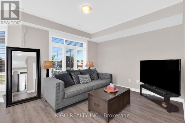 Bedroom with a single bed, nightstand, lamp, and a window with grey curtains. - 4119 Palermo Common, Burlington