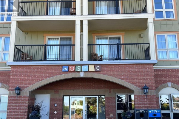 Close-up of the entrance with brick archway and decorative plants. - 412 - 190 Jozo Weider Boulevard, Blue Mountains