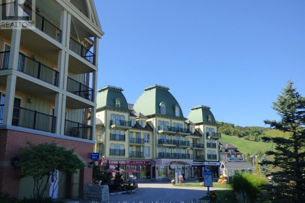 View of the adjacent building with green roofs and shops below. - 412 - 190 Jozo Weider Boulevard, Blue Mountains