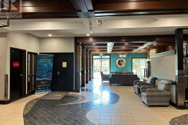 Lobby area with patterned tile floor and seating arrangements. - 412 - 190 Jozo Weider Boulevard, Blue Mountains