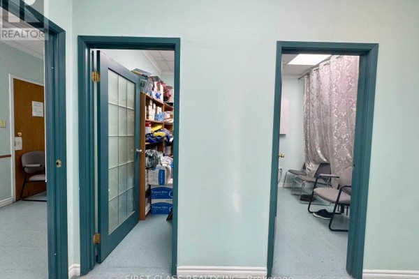 Office room with light blue walls, desk, chairs, computer, and window blinds. - 412 - 4002 Sheppard Avenue E, Toronto