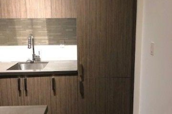 Stainless steel sink and faucet with grey tiled backsplash in the kitchen. - 412 - 501 St Clair Avenue W, Toronto