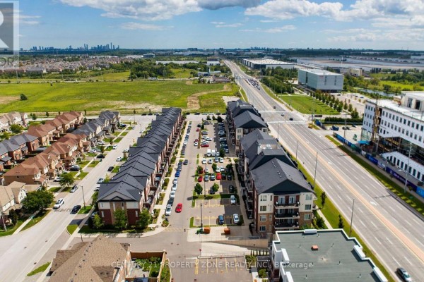 Aerial view of a street with apartment buildings and townhouses. - 412 - 54 Sky Harbour Drive, Brampton