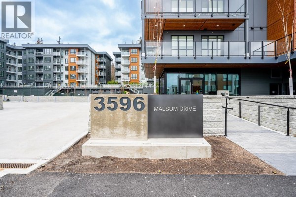Building address sign: 3596 Malsum Drive, with modern architectural details. - 412 3596 Malsum Drive, North Vancouver