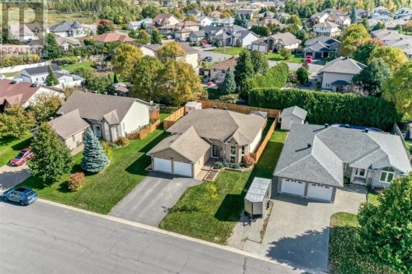 Aerial view of a suburban neighborhood with houses and manicured lawns. - 4120 Heritage Drive, Hanmer