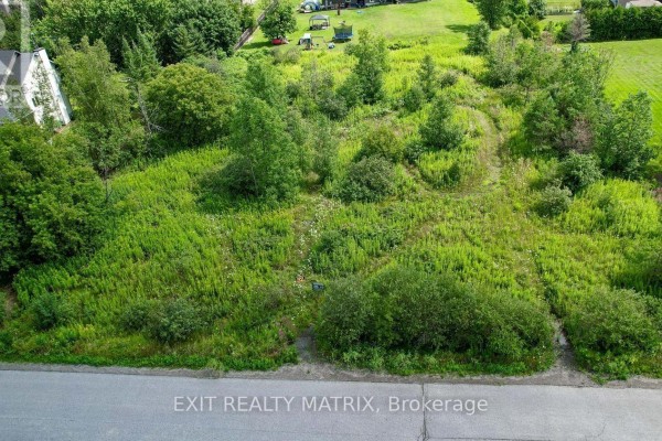 Close-up aerial view of a snow-covered lot with scattered trees and open spaces. - 4123 Calbrent Way, Ottawa
