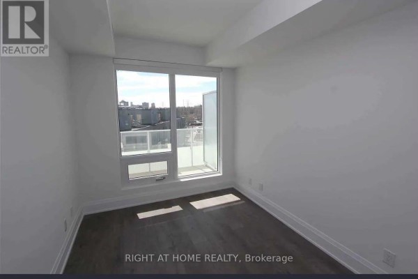 Room with large window and glass door leading to an outdoor balcony area. - 413 - 20 Brin Drive, Toronto