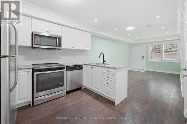 Kitchen with white cabinetry, stainless steel appliances, granite countertops, and laminate flooring. - 413 - 8 Drummond Street, Toronto