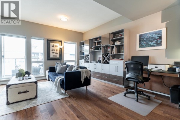 Interior view of a modern kitchen with a breakfast bar and hallway. - 413 317 Bewicke Avenue, North Vancouver