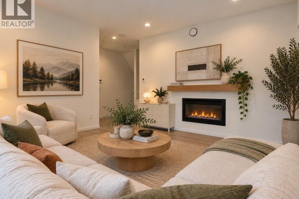 Living room with fireplace, sectional sofa, wood coffee table, and art on wall. - 4136 Beatrice Street, Vancouver