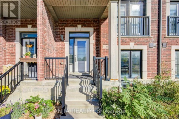 Close-up of the front entrance of a townhouse, showing a white door and stairs. - 4146 Highway 7 Road E, Markham