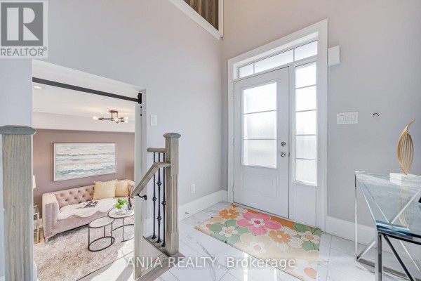 Interior foyer with white double doors, marble tile floor, and a view into a living room. - 4146 Highway 7 Road E, Markham