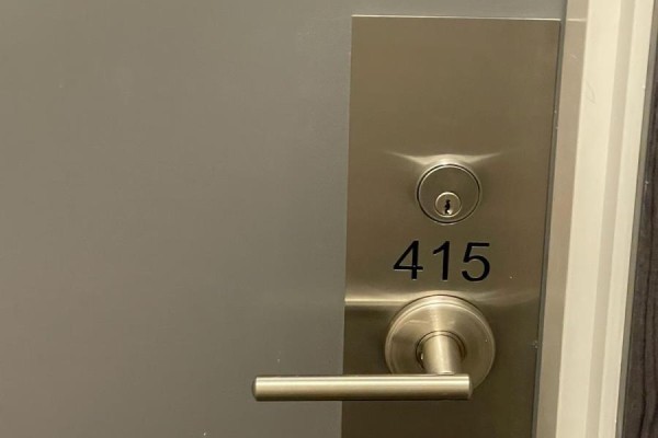 Close-up of the apartment door with number 415 and a stainless steel handle - 415 - 38 Forest Manor Road, Toronto