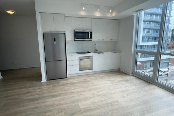 Open-concept kitchen area with large windows and light-colored flooring - 415 - 38 Forest Manor Road, Toronto
