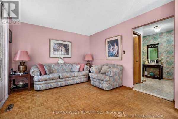 Dining room with white table and chairs, display cabinets, and glass door to backyard. - 4157 Ottewell Crescent, Mississauga