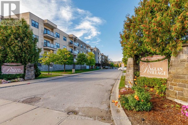 Street view of Raglan Village apartment buildings with trees and landscaping. - 416 - 91 Raglan Street, Collingwood