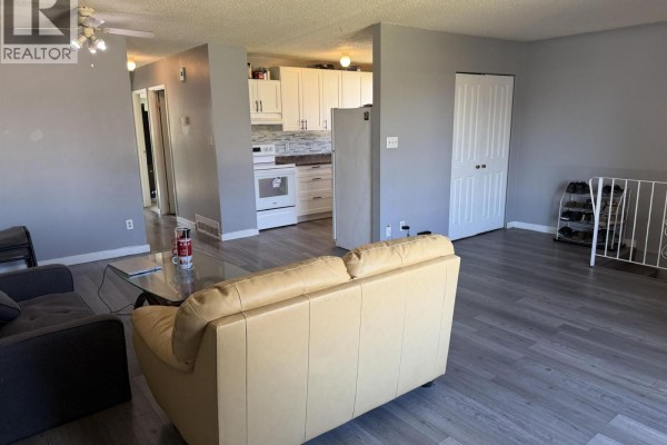 Exterior view of the right side of the duplex, showing Unit 420 entrance and window. - 416-420 W 3rd Street, Vanderhoof