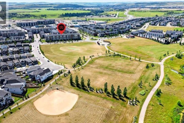 Aerial view of apartment buildings and residential homes with parks and baseball field. - 418, 10 Walgrove Walk Se, Calgary