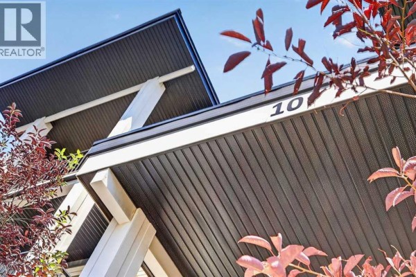 Close-up exterior view of building number 10 with modern dark roof overhangs. - 418, 10 Walgrove Walk Se, Calgary