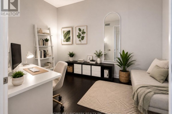 Home office with a white desk, computer, chair, shelving unit, and a daybed with accent pillows. - 418 - 199 Richmond Street W, Toronto
