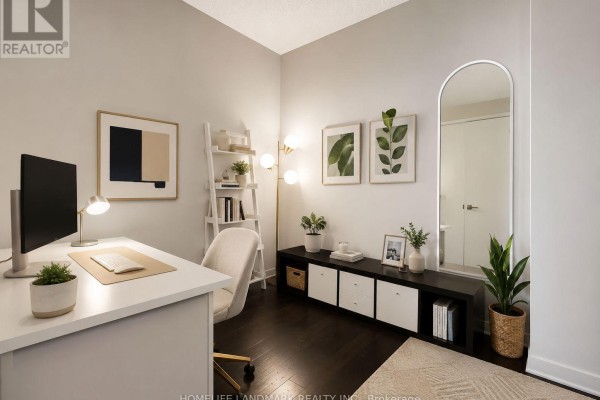 Second view of the home office featuring a desk, chair, floor lamp, shelving, and a large arched mirror. - 418 - 199 Richmond Street W, Toronto