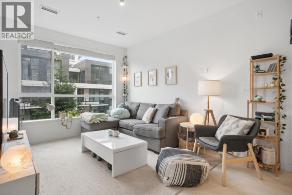 Living room furniture including a sectional sofa, armchair, and floor lamp. - 418 3581 Ross Drive, Vancouver