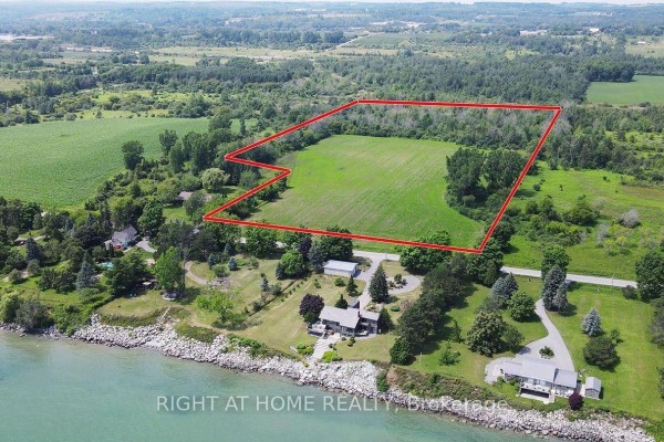 Aerial view of property with a large house, pool, and surrounding green landscape. - 418 Victoria Beach Road, Cramahe