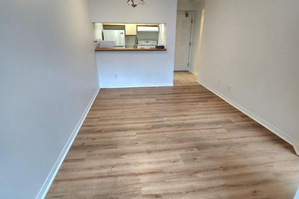 Open concept living and dining area with light wood laminate flooring. - 419 - 222 The Esplanade, Toronto