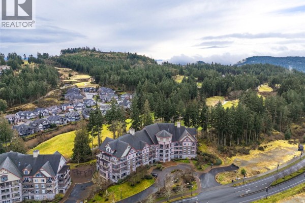 Exterior view of a multi-story apartment building with landscaped grounds - 419 1395 Bear Mountain Pkwy, Langford