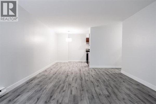 Floor plan of a two-bedroom apartment with dimensions, a balcony, primary bedroom, closet, and den/storage. - 419 9867 Manchester Drive, Burnaby