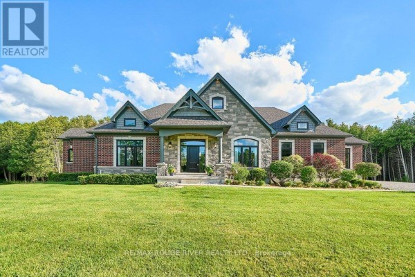 Spacious brick and stone ranch-style home with manicured lawn and landscaping. - 4199 Highway #2, Clarington
