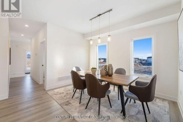 Dining room with a wooden table, grey upholstered chairs, and two rectangular windows. - 42(lot 20) Dusenbury Drive, Loyalist