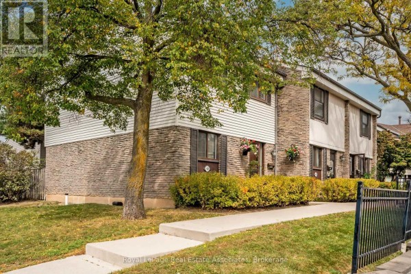Side view of townhouse exteriors with trees and lawn, showing numbered units. - 42 - 2779 Gananoque Drive, Mississauga