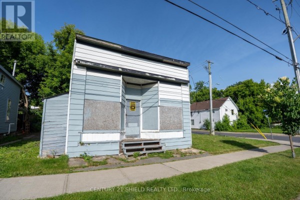 Exterior of a dilapidated light blue and white building with boarded-up windows and a weathered facade. - 42-46 Marlborough Street S, Cornwall