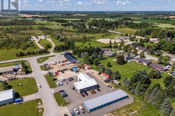 Overhead view of commercial property with L-shaped main building, storage units, and parking lot. - 42 Hanbury Street, Southgate