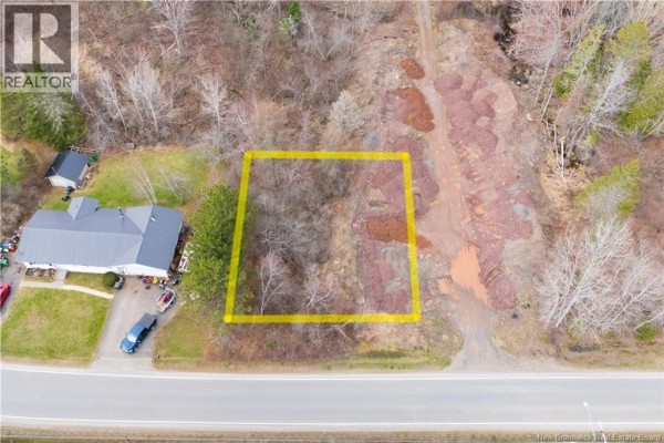 Aerial view of a sloped lot with a yellow border, next to a road and residential buildings. - 42 Sunrise Estates Drive, New Maryland