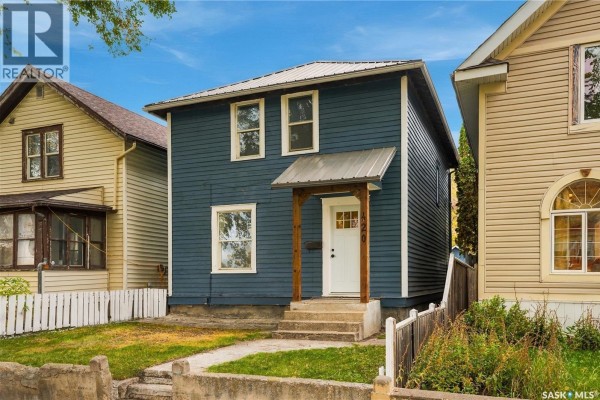 Exterior of a large brick building with a tower and large trees. - 420 J Avenue N, Saskatoon
