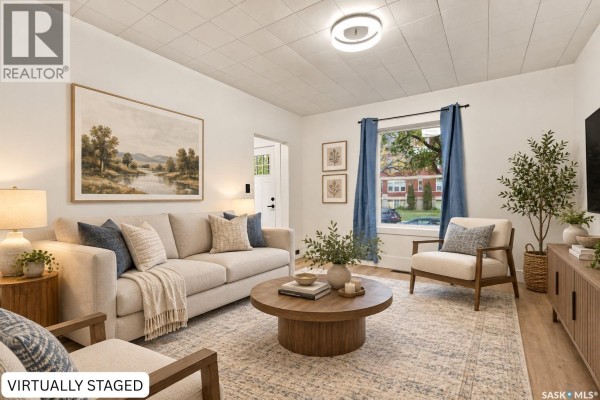 Interior view of a room with white walls, a patterned floor, and wooden railings. - 420 J Avenue N, Saskatoon