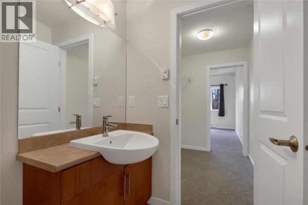 Kitchen area with light wood cabinets, beige countertops, and stainless steel appliances. - 4205 27 Street Unit# 103, Vernon
