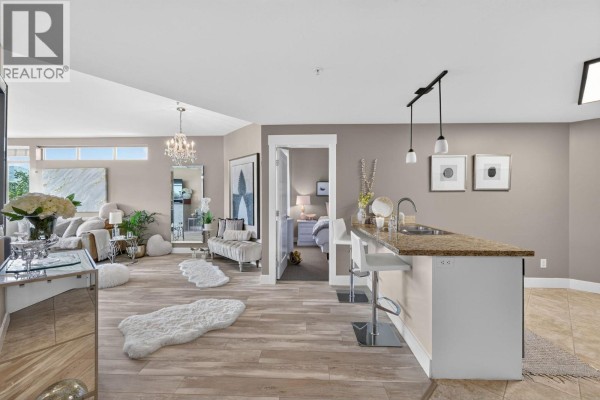Open concept living area showing living room, dining bar, and kitchen. - 4205 Gellatly Road Unit# 336, West Kelowna