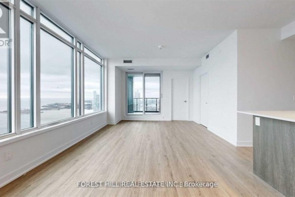 Living room with floor-to-ceiling windows offering a city and water view. - 4208 - 1928 Lake Shore Boulevard W, Toronto
